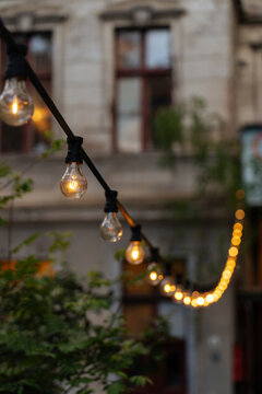 Small strung of warm lamps on city street