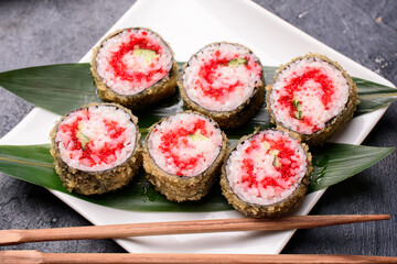 Sushi rolls made of rice, smoked eel, cream cheese and flying fish roeSet hot rolls with avacado,...