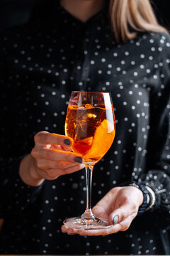 Elegant female with orange cocktail