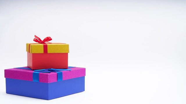 Stop motion animation of two bright boxes for gifts. Concept for the holidays 4 k video