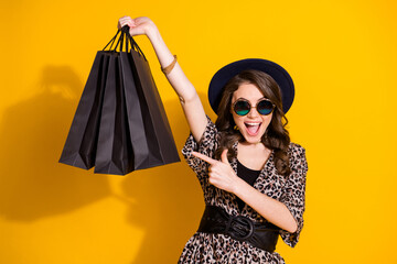 Portrait of amazed excited girl shopping center client point index finger bags she buy store ear...