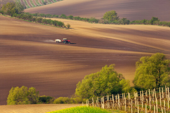 Cultivation the soil by a tractor.