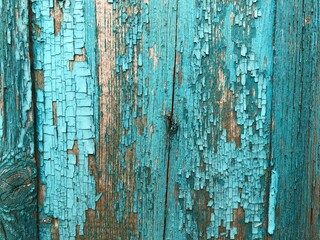 The old wooden planks of a barn with peeling paint