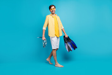 Full length photo positive guy tourist go walk beach try watersport hold mask goggles tube flippers...