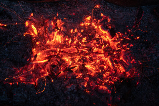 Glowing embers with sparks - firewoods Close-Up