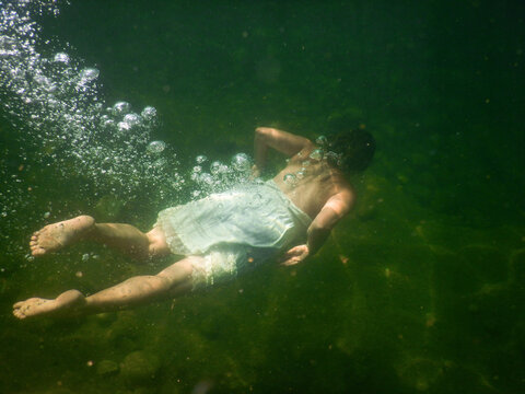Woman diving in a deep lake