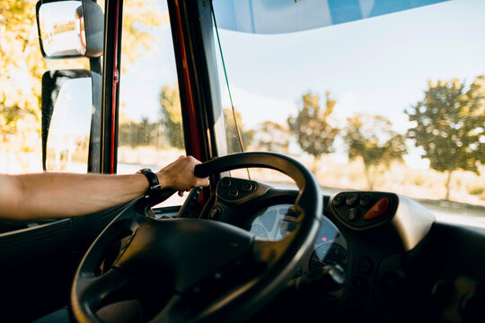 Scene of a truck driver driving on the road.