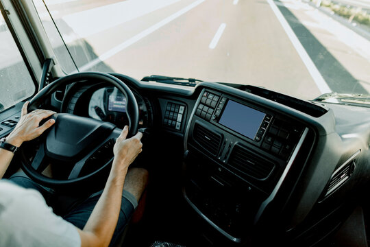 Scene of a truck driver driving on the road.