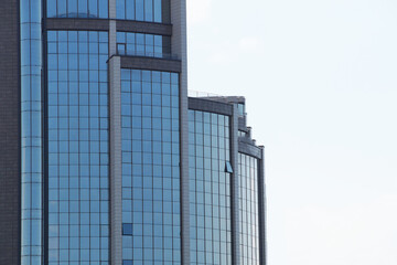 modern glass facade of a skyscraper against the sky