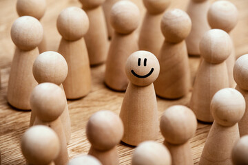 Standing out happy in the middle of a crowd