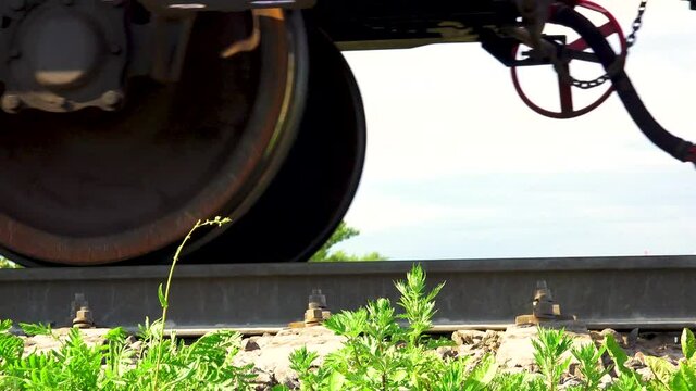 Wagon wheels roll on railway tracks.