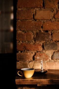 Yellow cup and glass kettle with coffee.