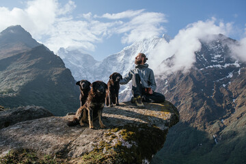 Man In A Mountains With A Dogs