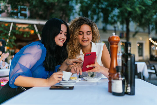 Best friends ladies looking at mobile or smart phone