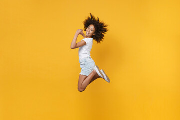 Full length portrait of smiling little african american kid girl 12-13 years old in white t-shirt...