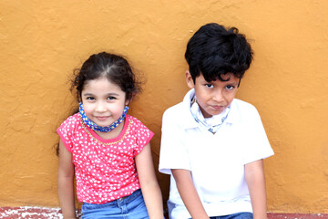 6-year-old boy and girl with protective face masks for virus covid-19, in the park, new normal