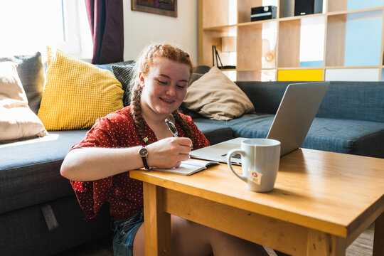 Red Hair woman Sitting on the floor with Laptop Computer