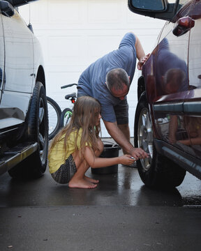 Father and Daughter Washing Car