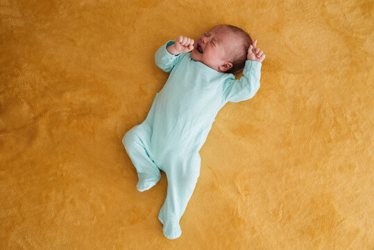 Baby crying on soft blanket