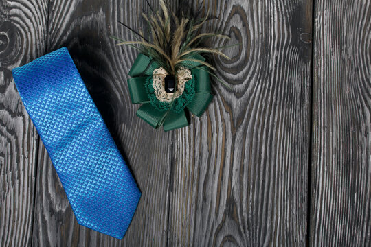 Men's tie and women's brooch. Accessories for spouses. Love and Togetherness Objects. On painted boards.