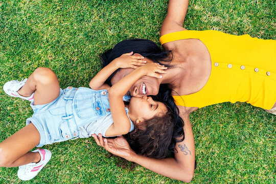 Beautiful woman with her cute daughter playing together