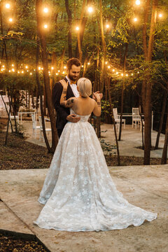 Newlyweds Dancing Outdoors In Romantic Scenery