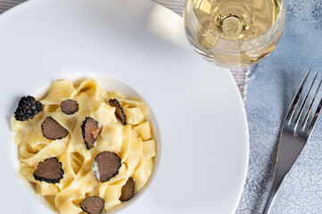 Dish of delicious italian pasta tagliatelle with truffle mushroom chips