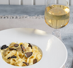 Dish of delicious italian pasta tagliatelle with truffle mushroom chips