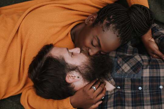 Couple Lying and Kissing on Blanket