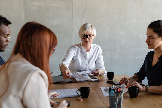 Multiethnic employees working at project in conference room