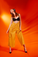 trendy young woman with headphone on colorful background