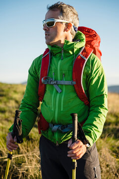 Sportive middle age pilgrim watching landscape in Alto do Cebreiro, Spain