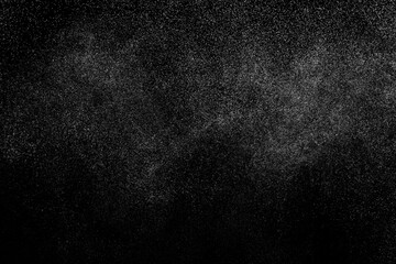 Abstract splashes of water on black background. Freeze motion of white particles. Rain, snow overlay texture.