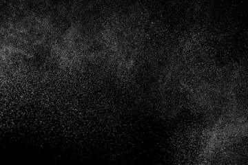 Abstract splashes of water on black background. Freeze motion of white particles. Rain, snow overlay texture.