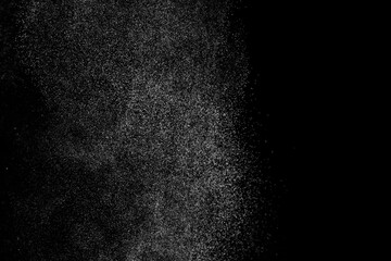 Abstract splashes of water on black background. Freeze motion of white particles. Rain, snow overlay texture.
