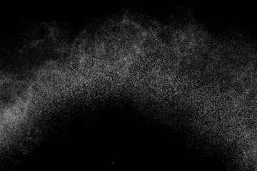 Abstract splashes of water on black background. Freeze motion of white particles. Rain, snow overlay texture.