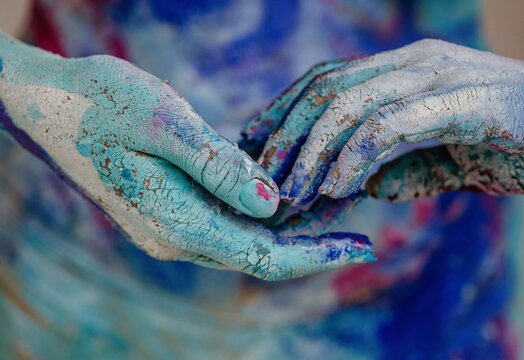 Crop model clasping colorful hands