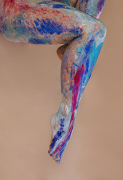 Legs with bright blue and pink body art