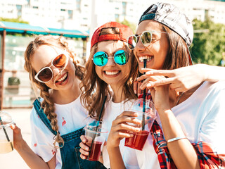 Three young beautiful smiling hipster girls in trendy summer clothes.Sexy carefree women posing...