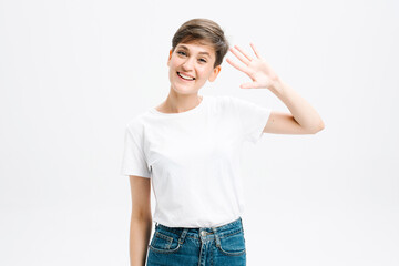 Hello how are you. Cheerful positive good-looking girl student in striped t-shirt raise hand and waving friendly.