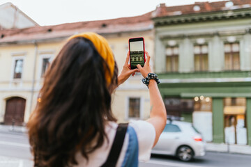 Woman taking pictures of the buildings. Blurry Background