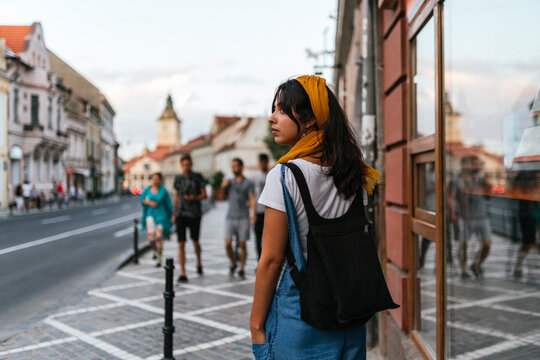 rear view of a young woman walking on the street