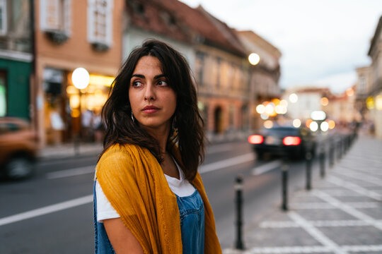 portrait of young woman with a yellow scarf on her shoulders