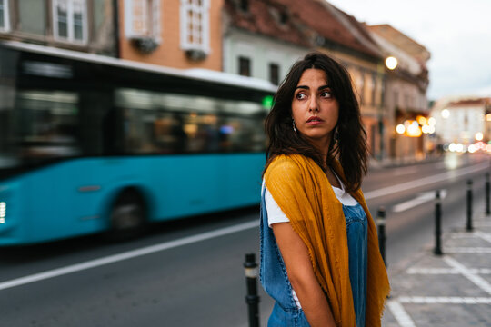Portrait of a attractive woman looking up her shoulder aside