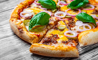 Pizza with Mozzarella cheese, Bolognese sauce, minced meat and vegetables. Italian pizza on wooden background.