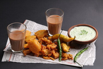 Crispy pakoras, delicious street food, favourite indian snack in monsoon served with Hot Tea