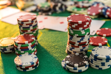 view of a gaming table with many poker card and chips green mat