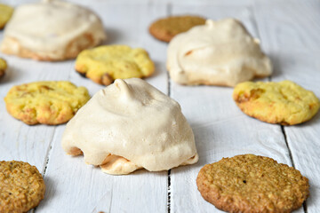 Home made delicious meringue French cake made of baked whipped egg whites and sugar and pile of delicious cookies
