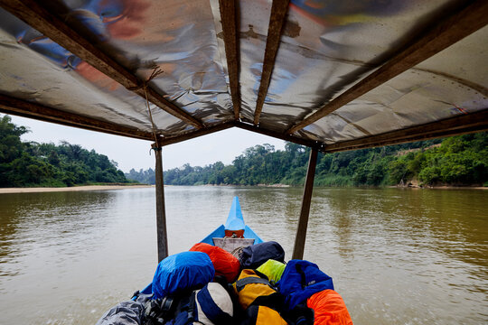 Long tail boat riding along river at tropical area, Taman Negara