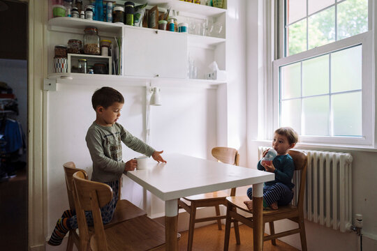 Kids drinking in morning in kitchen